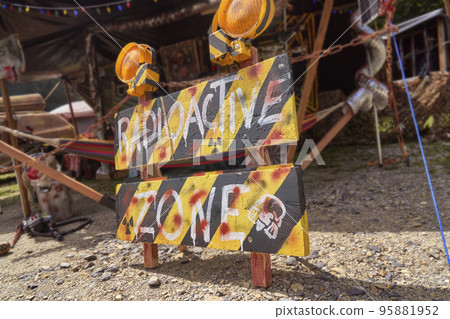 Radioactive Zone warning sign outside a tent camp after the destruction of the world Radioactive Zone warning sign outside a tent camp after the destruction of the world 95881952