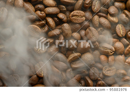 Black coffee beans with a slight haze from the steam, the texture of coffee beans. 95881976