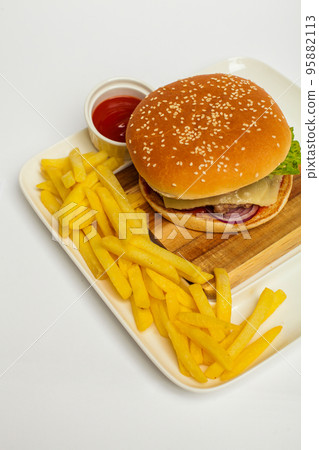 Delicious hamburger and delicious fries on white background Delicious hamburger and delicious fries on white background 95882113