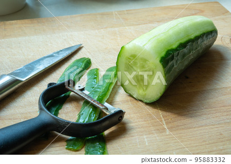 A close-up of kitchen accessories for peeling cucumber 95883332