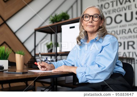 caucasian Middle aged older businesswoman in office workplace caucasian Middle aged older businesswoman in office workplace 95883647
