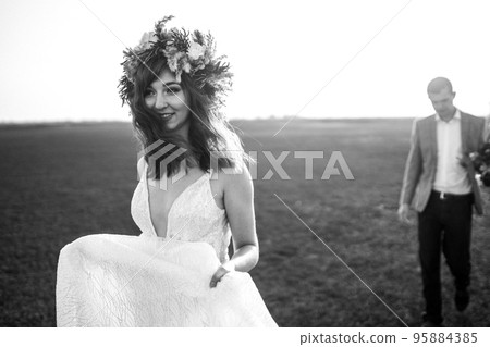young and beautiful bride and groom enjoy each other. Wedding day in boho style. Warm summertime. young and beautiful bride and groom enjoy each other. Wedding day in boho style. Warm summertime. 95884385