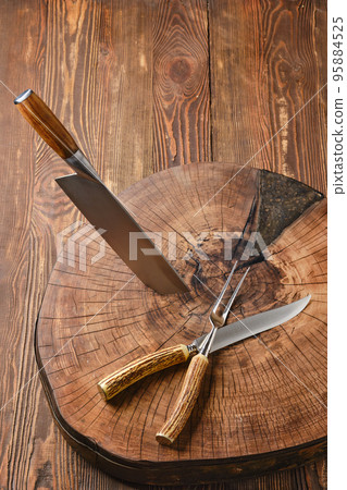 Top view of cleaver, fork and knife on wooden blockhead 95884525