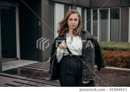 Portrait of fashion retro girl in white shirt, suspenders and black wide pants. Copy, empty space for text. Beautiful woman wearing elegant vintage outfit, posing. Portrait of fashion retro girl in white shirt, suspenders and black wide pants. Copy, empty space for text. Beautiful woman wearing elegant vintage outfit, posing. 95884653