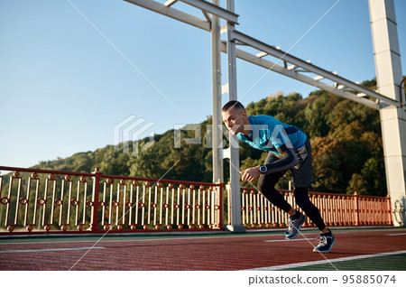 Adult speed runner running on racetrack Adult speed runner running on racetrack 95885074
