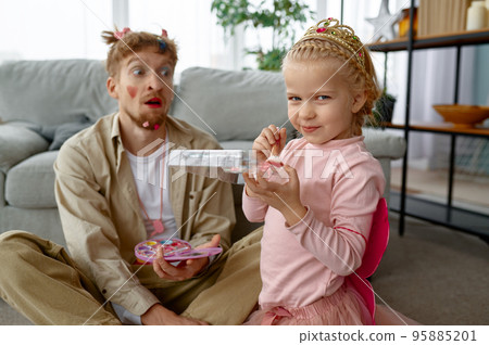 Father spends time with daughter, focus on smiling daughter 95885201