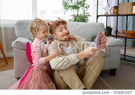 Little happy daughter and father with funny makeup 95885207