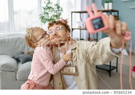 Joyful father and daughter making funny selfie 95885234