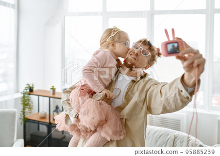 Joyful father and daughter making funny selfie 95885239