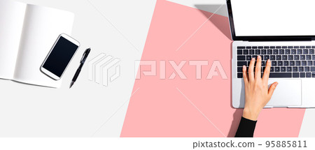 Person using a laptop computer 95885811