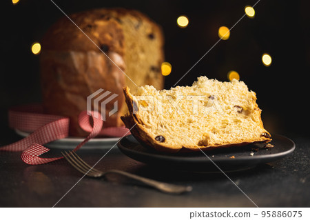 Panettone Christmas Cake. Italian sweet bread on plate on dark table. Panettone Christmas Cake. Italian sweet bread on plate on dark table. 95886075