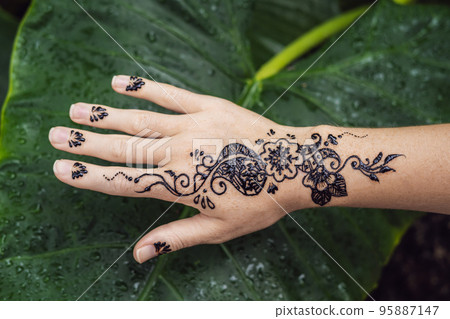 Picture of human hand decorated with henna Tattoo. mehendi hand Picture of human hand decorated with henna Tattoo. mehendi hand 95887147