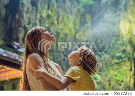 Mom and son in the background of Batu Caves, near Kuala Lumpur, Malaysia. Traveling with children concept 95887250