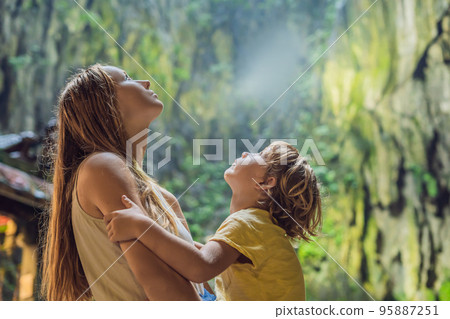 Mom and son in the background of Batu Caves, near Kuala Lumpur, Malaysia. Traveling with children concept 95887251