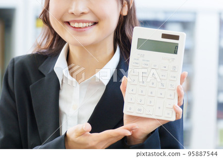 Business woman with calculator 95887544