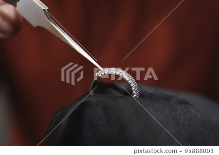 Beautiful ring with gemstones in jeweler's workshop, closeup 95888003