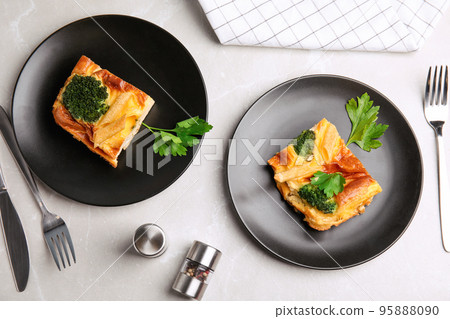 Tasty broccoli casserole served on grey marble table, flat lay Tasty broccoli casserole served on grey marble table, flat lay 95888090