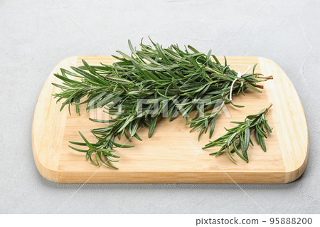 Bunch of fresh rosemary on light grey table Bunch of fresh rosemary on light grey table 95888200