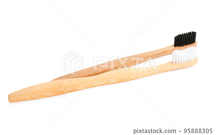 Natural bamboo toothbrushes with soft bristles isolated on white Natural bamboo toothbrushes with soft bristles isolated on white 95888305