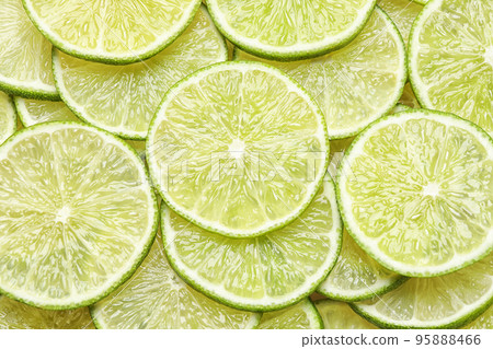 Many fresh juicy lime slices as background, top view 95888466