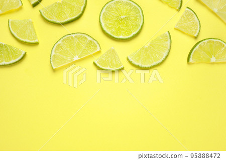 Juicy fresh lime slices on yellow background, flat lay. Space for text Juicy fresh lime slices on yellow background, flat lay. Space for text 95888472