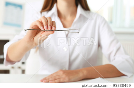 Speech therapist with logopedic probe in clinic, closeup 95888499
