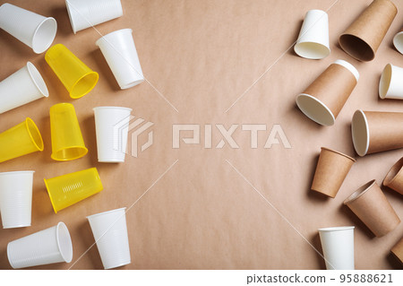 Flat lay composition with plastic and paper cups on beige background, space for text. Recycling concept Flat lay composition with plastic and paper cups on beige background, space for text. Recycling concept 95888621