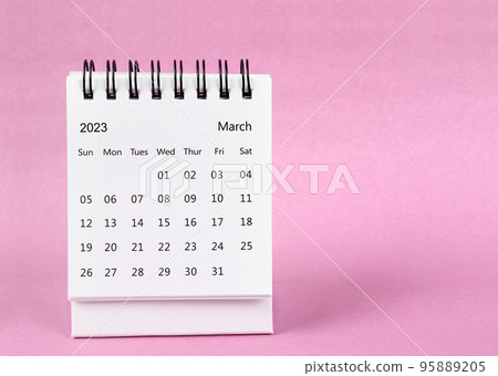 The March 2023 desk calendar on pink color background. 95889205