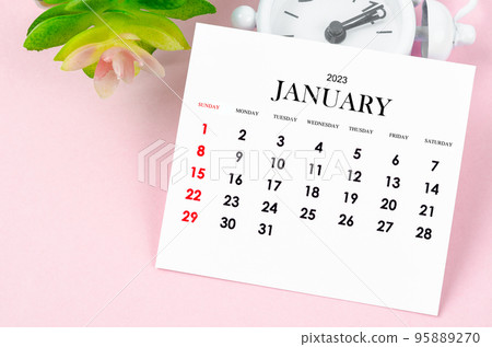 The January 2023 Monthly calendar for 2023 year with vintage alarm clock on pink colour background. 95889270
