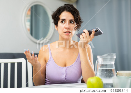 Positive joyful brunette woman talking on mobile phone 95889844