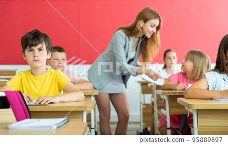 Kids sitting in classroom 95889897