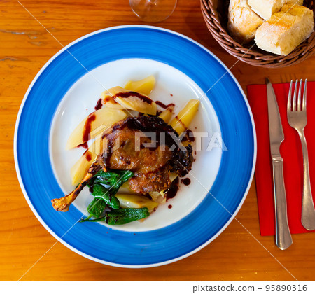 Duck leg confit in port with pear chutney 95890316