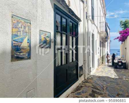 White-walled houses leading to a beach in Europe White-walled houses leading to a beach in Europe 95890881