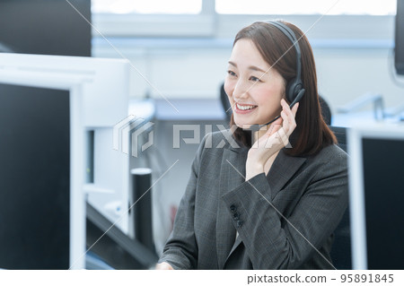 Business woman wearing a headset (online conference / call center) Business woman wearing a headset (online conference / call center) 95891845