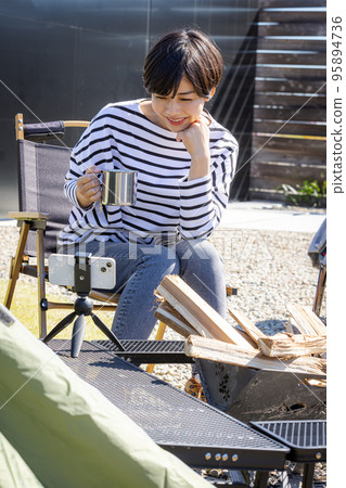 A woman live streaming a solo camp 95894736