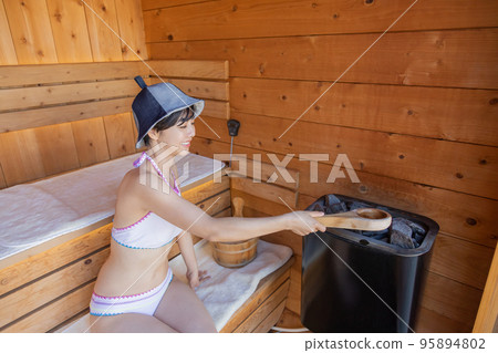 Totou, a woman getting fit in the sauna 95894802