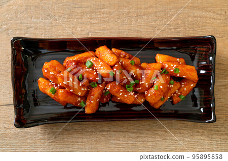 deep fried Korean rice cake (Tteokbokki) skewered with spicy sauce deep fried Korean rice cake (Tteokbokki) skewered with spicy sauce 95895858