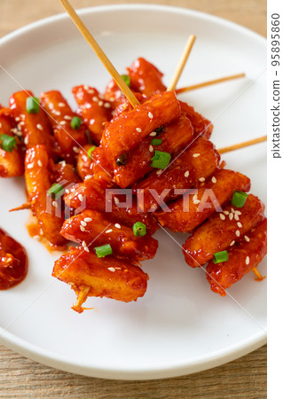 deep fried Korean rice cake (Tteokbokki) skewered with spicy sauce deep fried Korean rice cake (Tteokbokki) skewered with spicy sauce 95895860