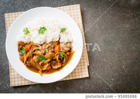 Japanese curry rice with sliced pork, carrot and onions 95895898