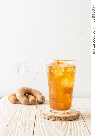 Delicious sweet drink tamarind juice and ice cube 95896057
