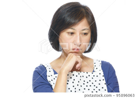 A depressed middle-aged woman with her hand on her chin A depressed middle-aged woman with her hand on her chin 95896063
