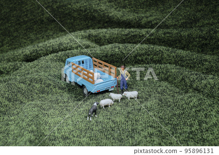 a mini of figure of sheep and famer 95896131