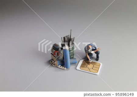 a Damaged sim card and miniature figure model scene. a Damaged sim card and miniature figure model scene. 95896149