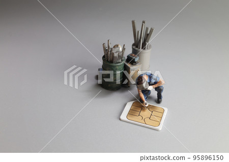 a Damaged sim card and miniature figure model scene. a Damaged sim card and miniature figure model scene. 95896150