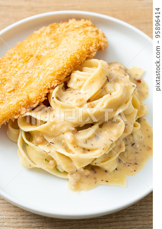 fettuccine pasta white cream sauce with fried fish fettuccine pasta white cream sauce with fried fish 95896414