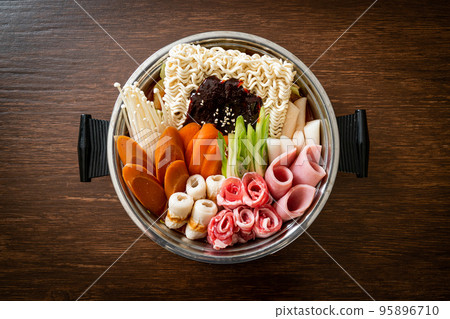 Budae Jjigae or Budaejjigae (Army stew or Army base stew). It is loaded with Kimchi, spam, sausages, ramen noodles and much more 95896710