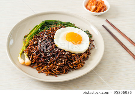 dried Korean spicy black sauce instant noodles with fried egg and kimchi dried Korean spicy black sauce instant noodles with fried egg and kimchi 95896986