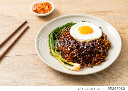 dried Korean spicy black sauce instant noodles with fried egg and kimchi dried Korean spicy black sauce instant noodles with fried egg and kimchi 95897080