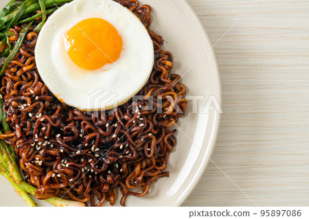 dried Korean spicy black sauce instant noodles with fried egg and kimchi dried Korean spicy black sauce instant noodles with fried egg and kimchi 95897086