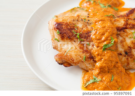 grilled chicken steak with red curry sauce 95897091